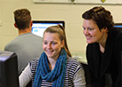 female staff member assisting student on computer